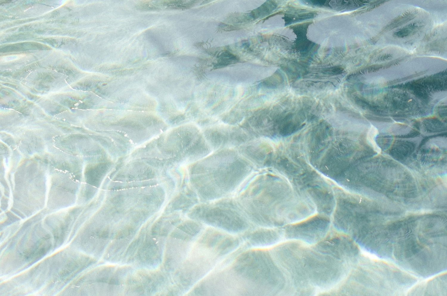 Rippling turquoise water texture evoking hydration from adaptogens in Syren Spreads beauty chocolate spread.
