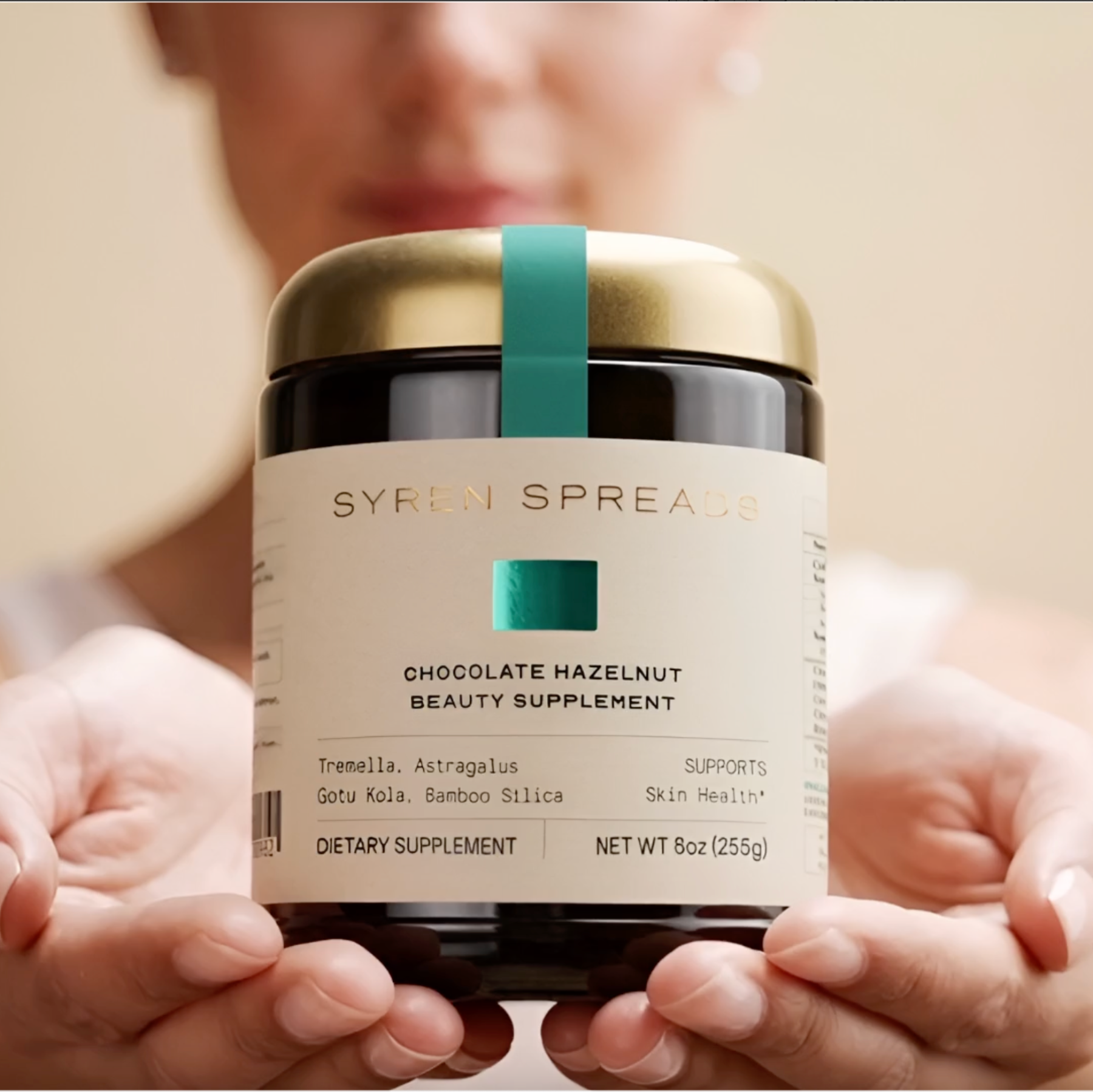 Women holding a jar of Syren Spreads Chocolate Hazelnut Beauty Supplement
