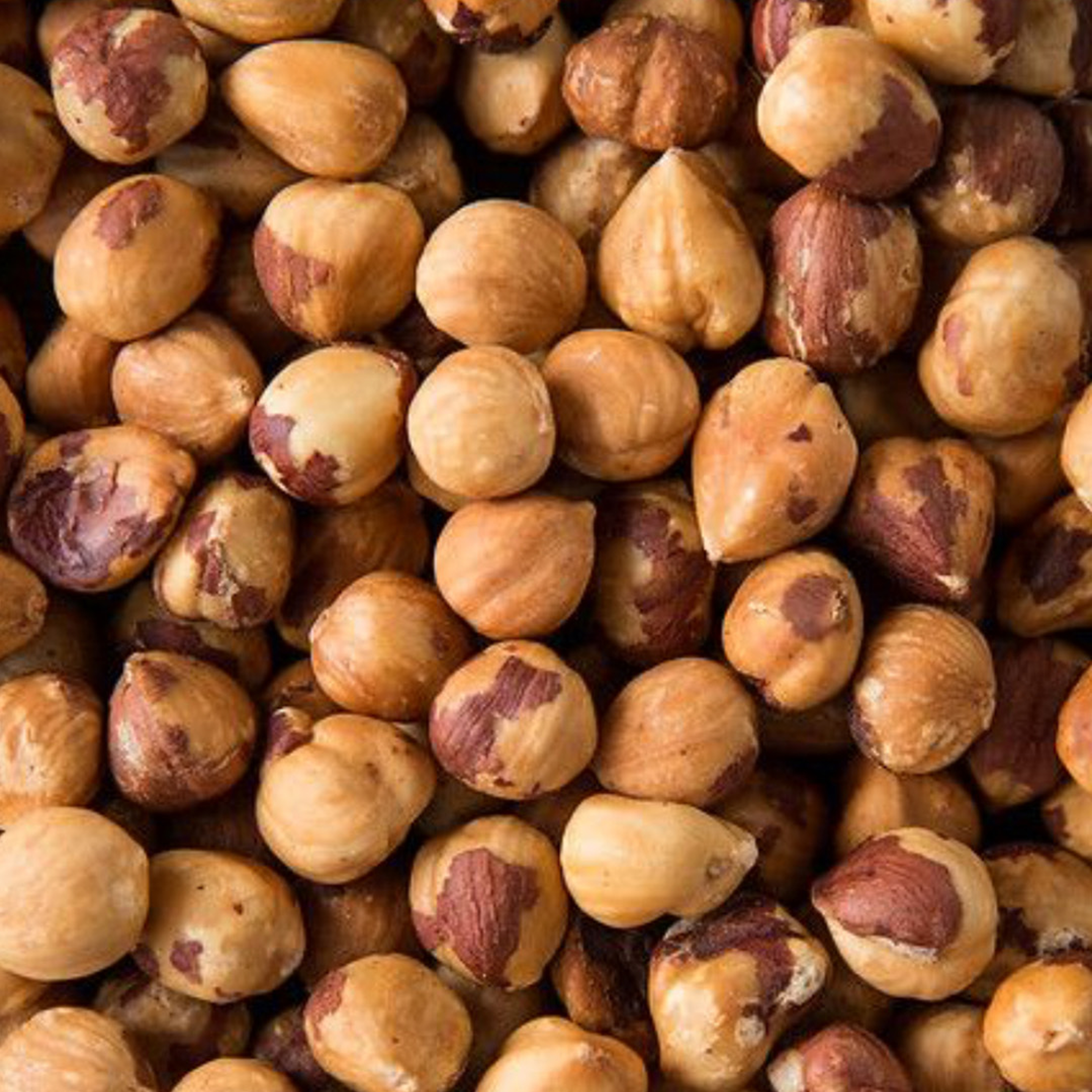 Close-up of hazelnuts with a brown and beige color.